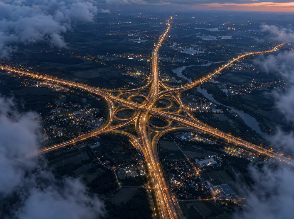 Highways converging into one interchange, seen from above at dusk
